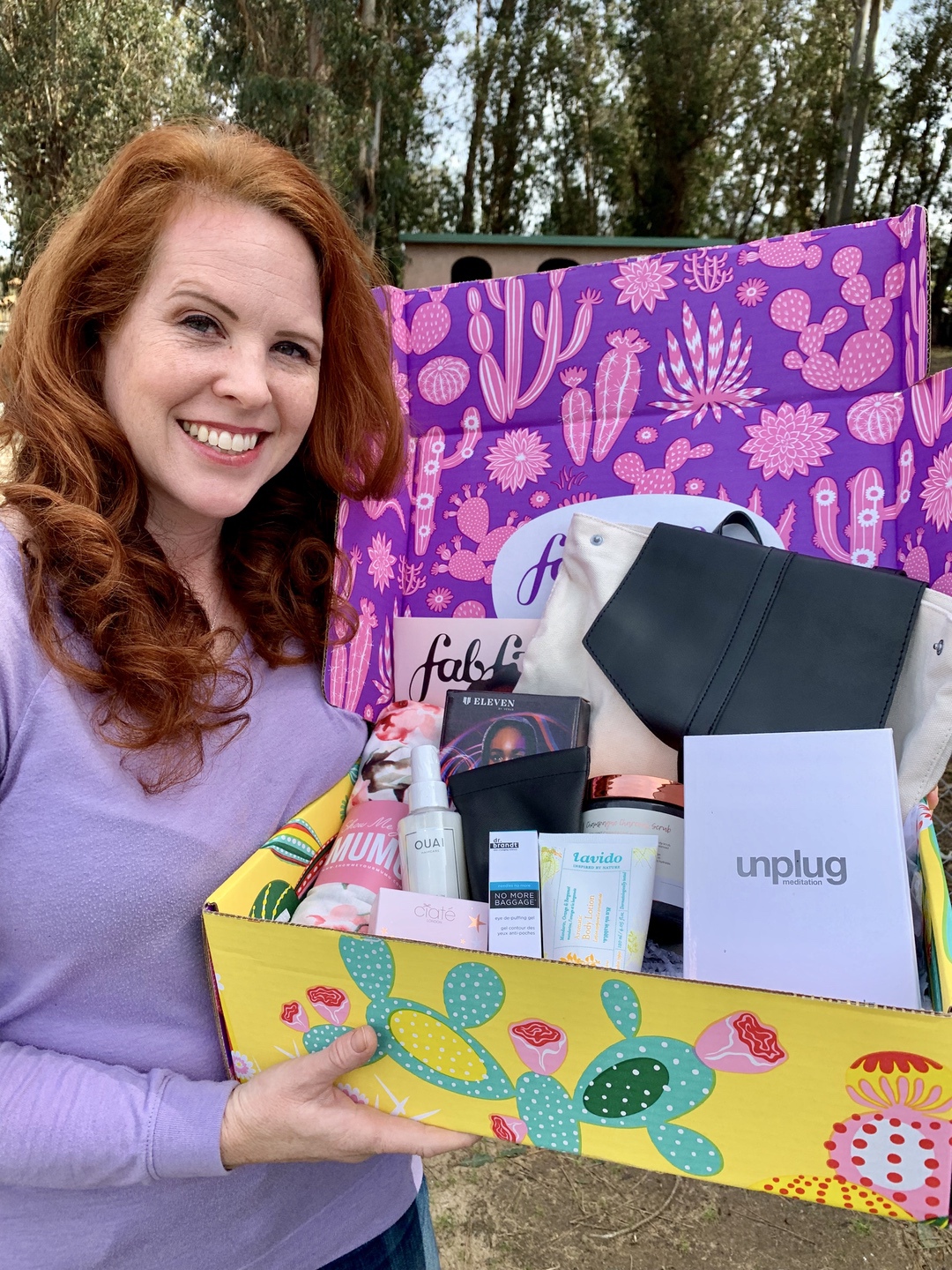 A woman holding a subscription box