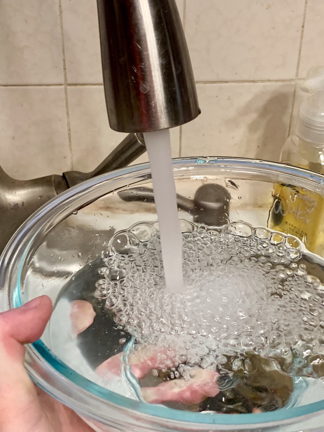 water from faucet filling up bowl