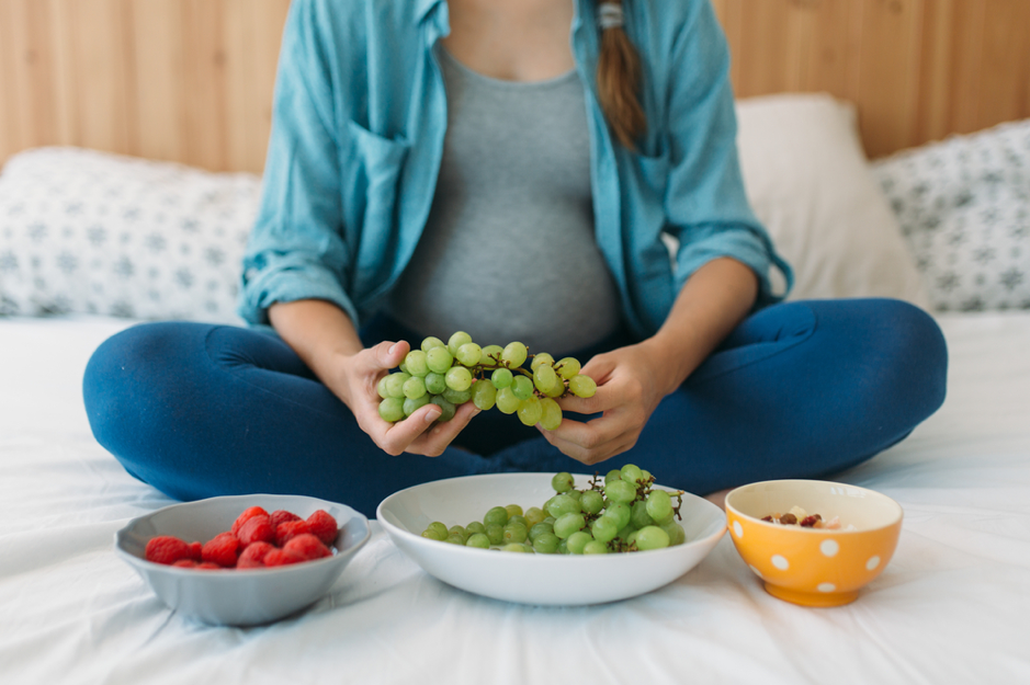 Pregnant belly and grapes
