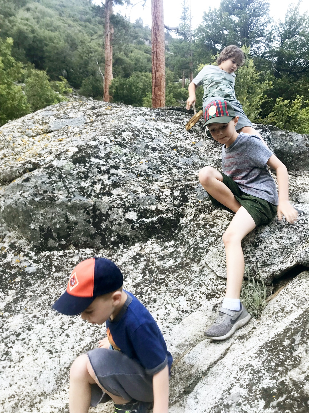 boys climbing on rocks