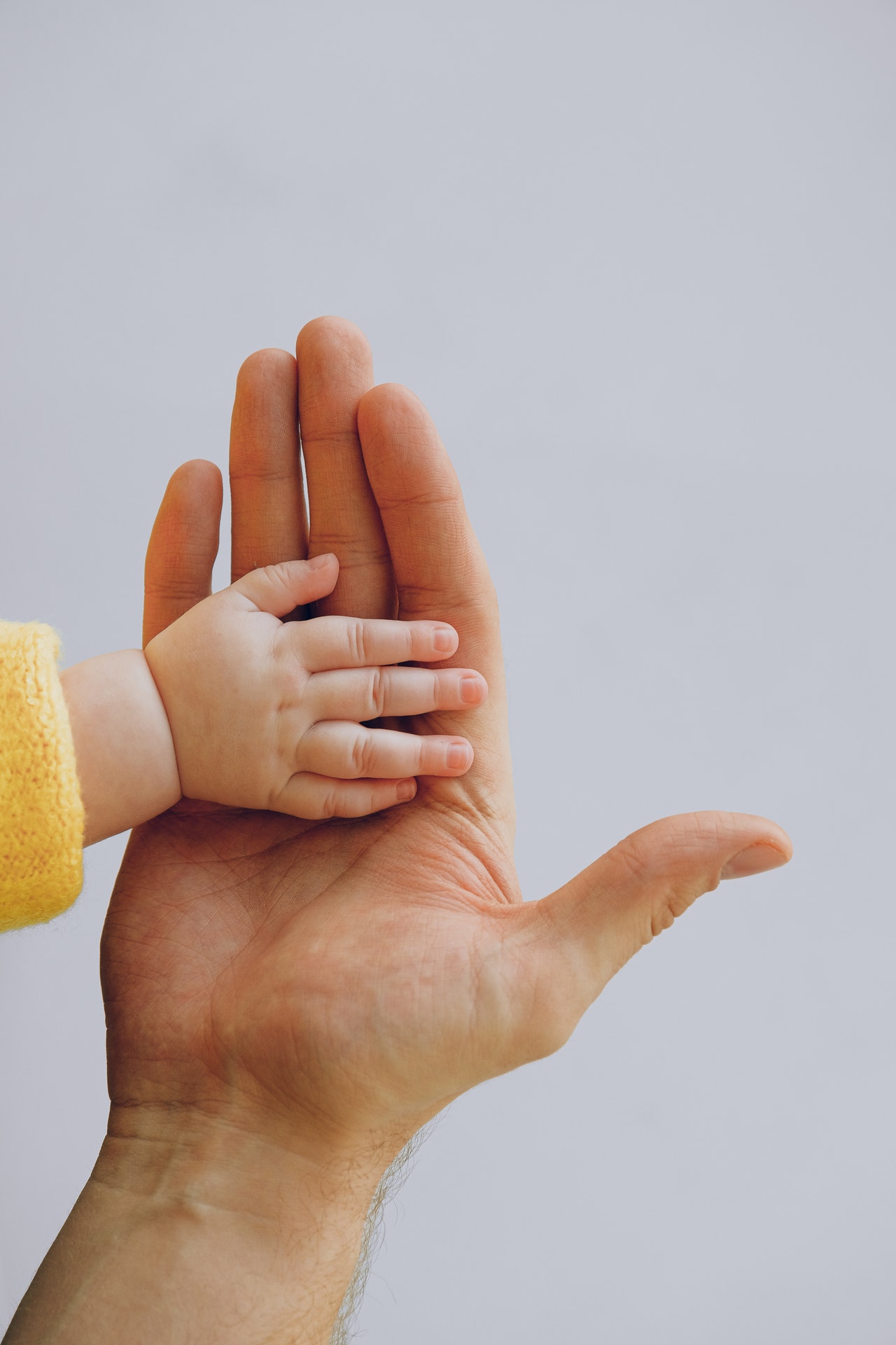parent hand with baby hand